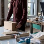 man wrapping packing boxes