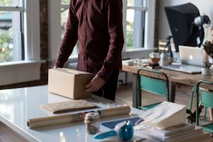 man wrapping packing boxes